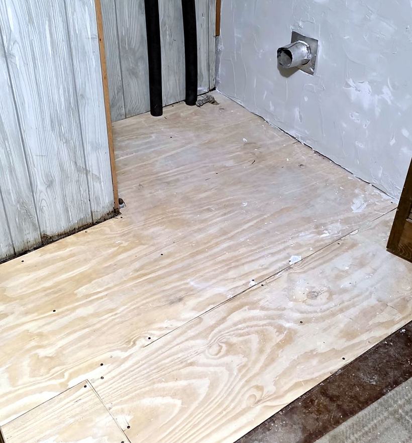 New plywood subfloor screwed down in the laundry room