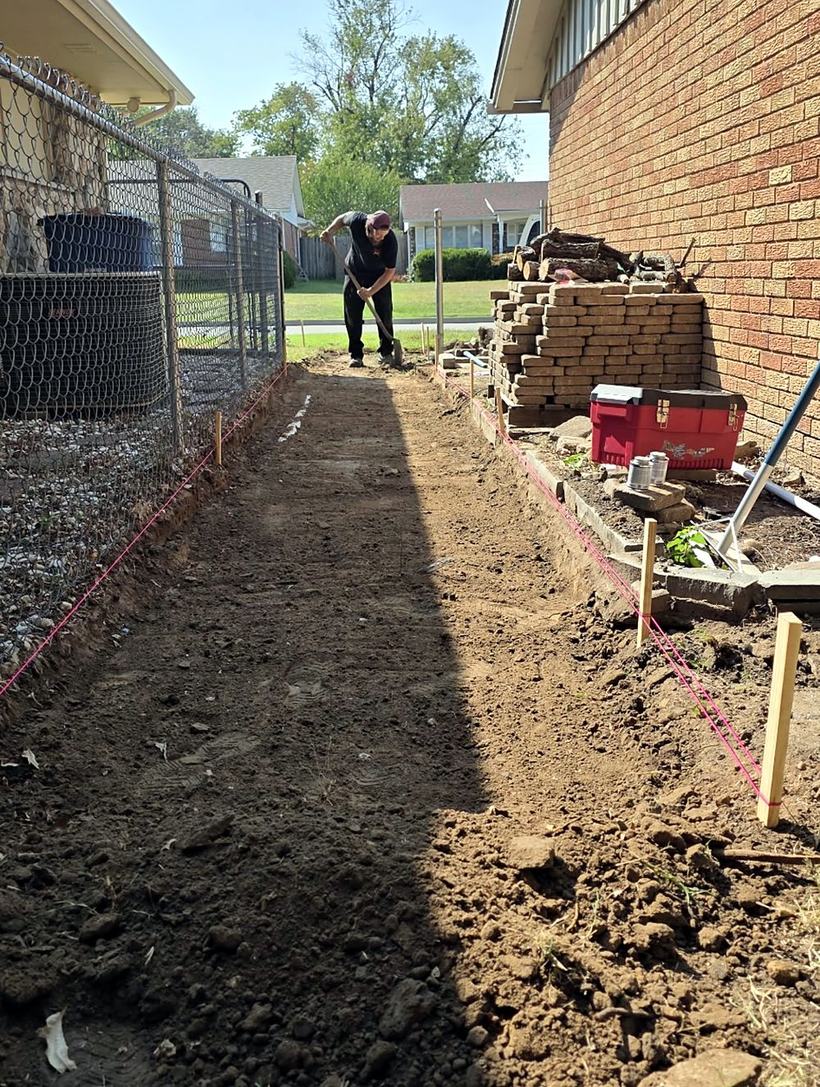 String lines set and the walkway path dug and graded with a shovel