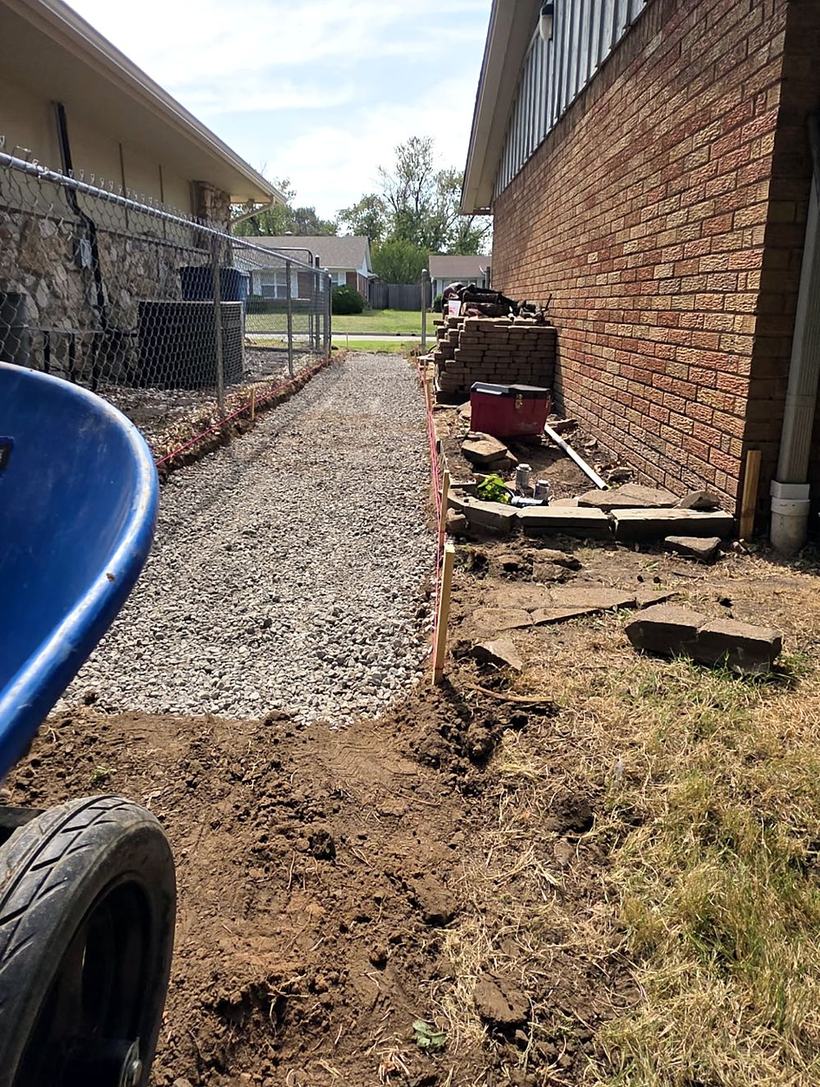 Gravel base spread inside the string lines for the new walkway